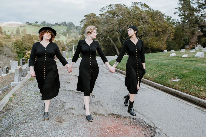 women wearing the fiona dress walking thought the cemetery